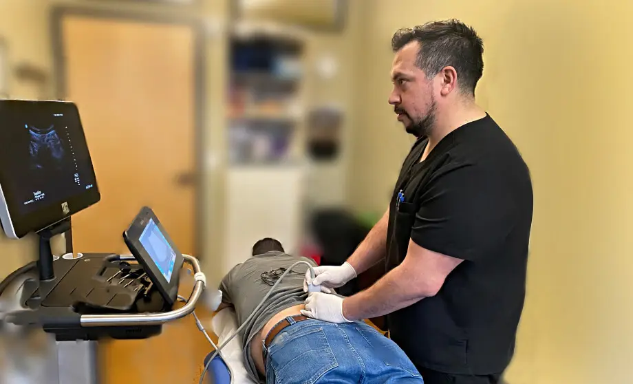 Dr. Kristian Flores performing an ultrasound-guided back exam